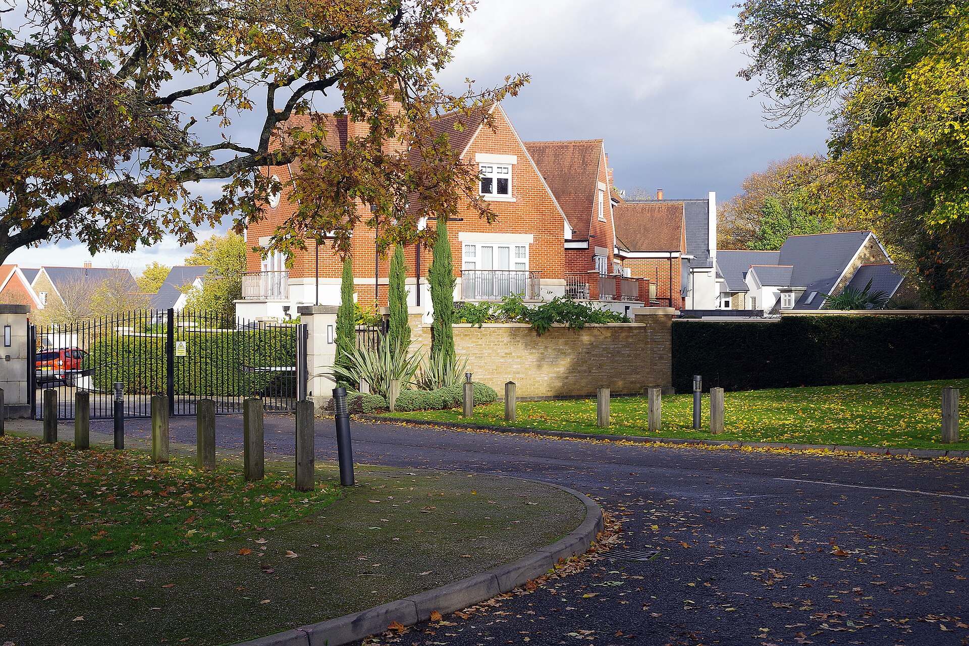Detached brick houses behind a gated entrance and drive at Chigwell Grange, Chigwell IG7