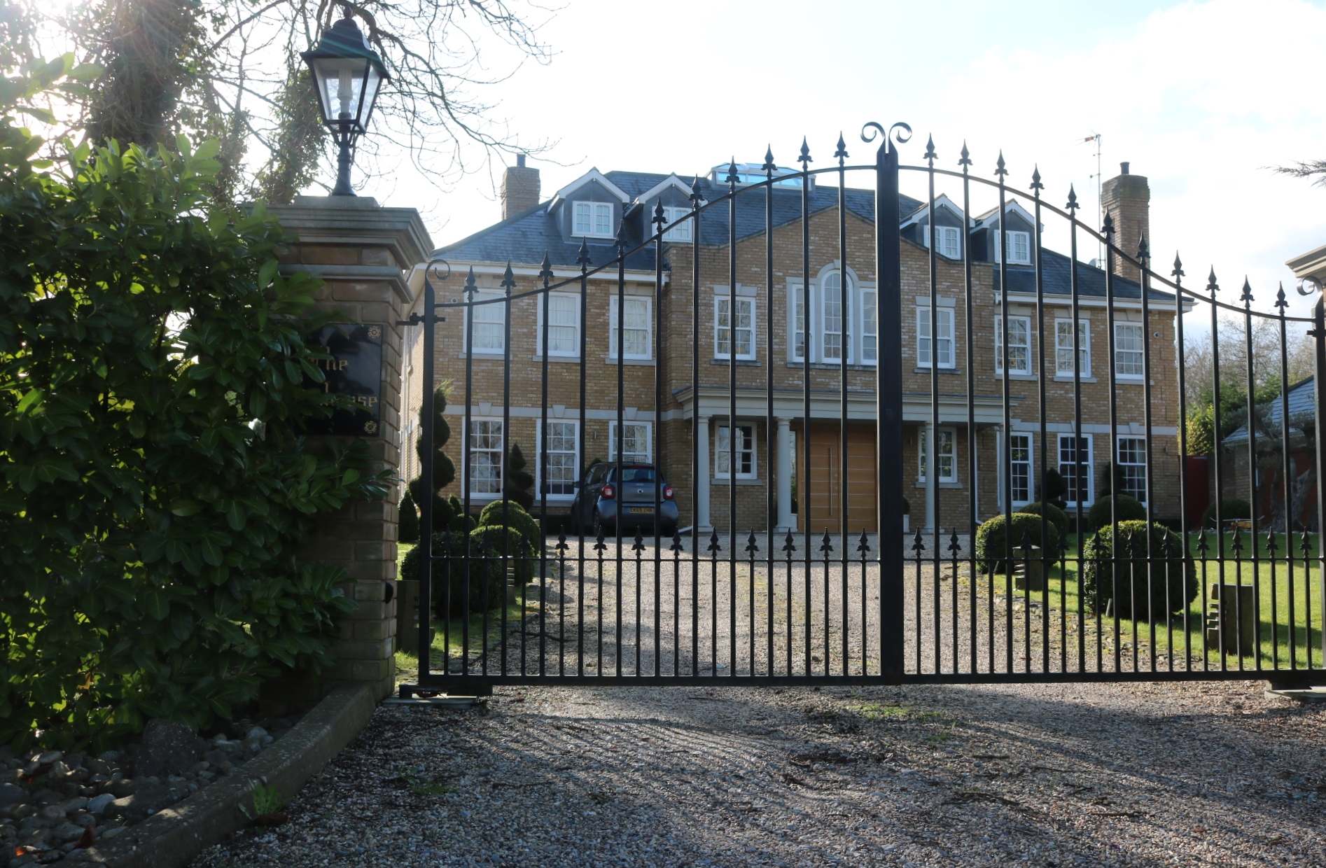 Large house behind wrought-iron gates on Gravel Lane, Chigwell Row
