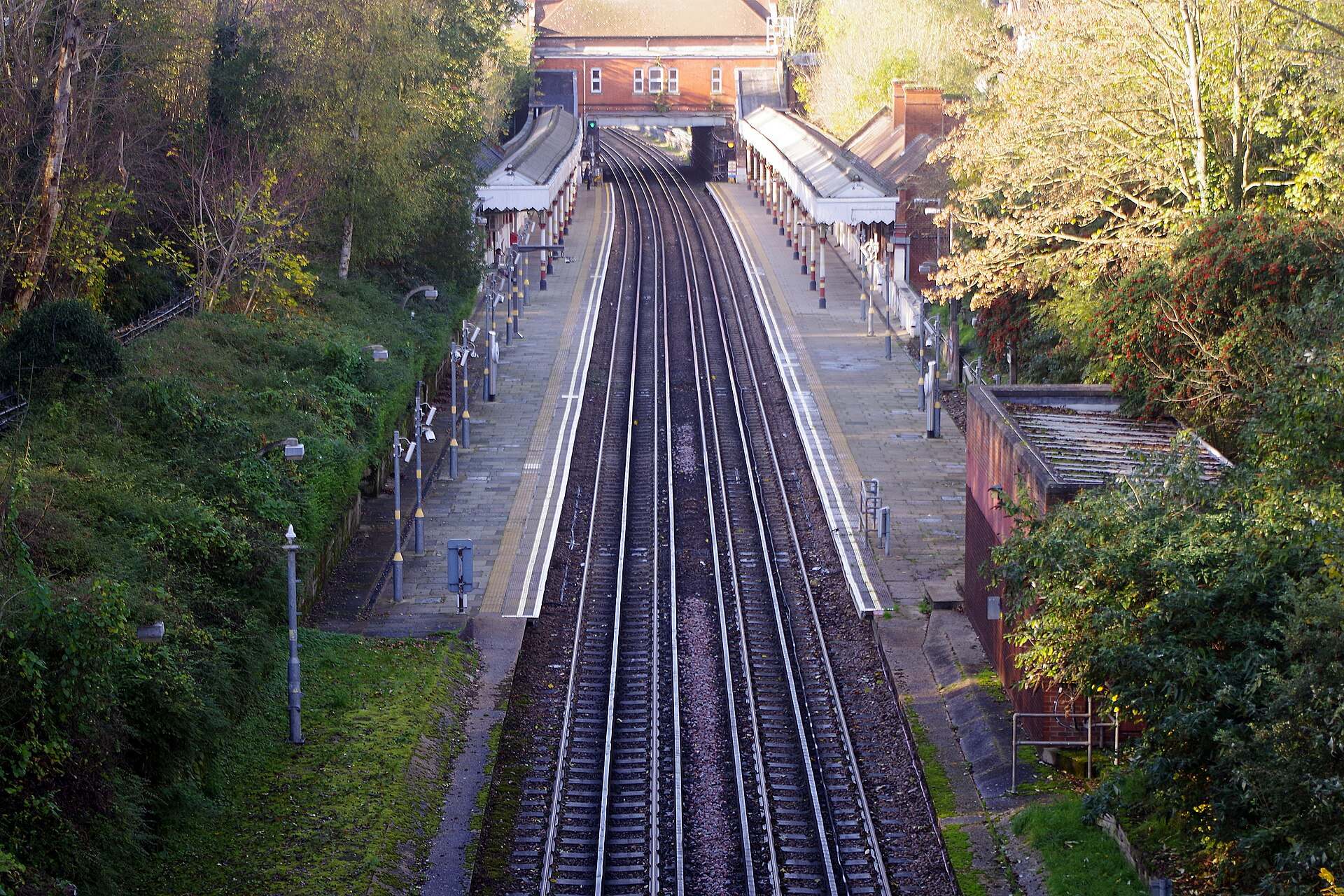 Central line tracks and platforms at Chigwell Underground station seen from the road bridge