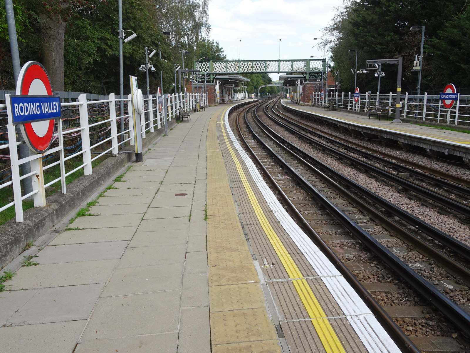 Platform and roundel at Roding Valley Underground station, near Chigwell and Buckhurst Hill